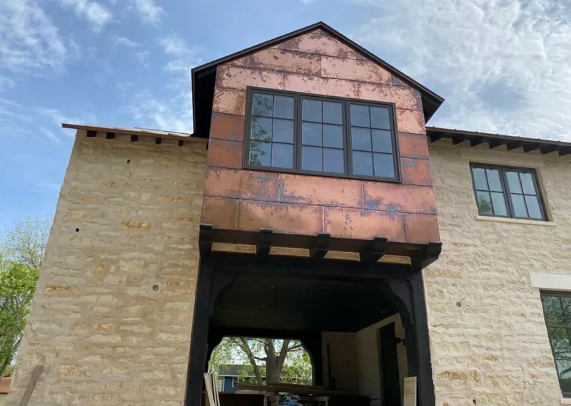 Copper metal panel facade on a stone building for Skylight Installation in West Allis